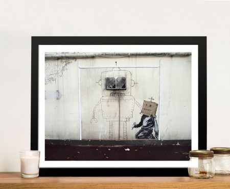 Framed canvas of the Banksy Torquay robot, muted street palette for a modern lounge