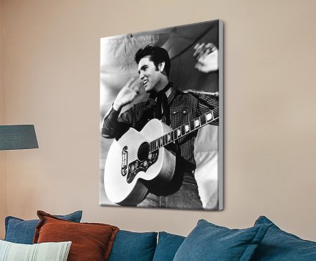 Black-and-white portrait of Elvis Presley singing in a classic performance pose