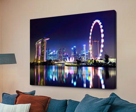 Singapore city skyline at dusk with illuminated towers reflected in the water