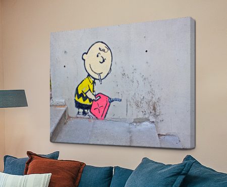 Banksy stencil of Charlie Brown holding a petrol can amid flames, satirical street-art canvas