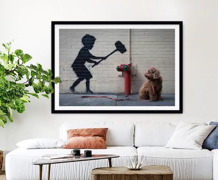 Banksy Hammer Boy framed print of a child swinging an oversized mallet at a fire hydrant