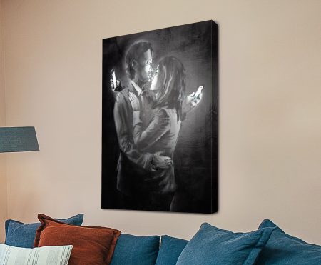 Banksy Mobile Lovers on canvas with a couple embracing over mobile screens