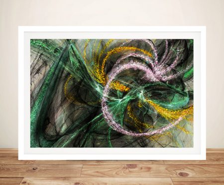 Stardust Abstract framed print with swirling green, pink and yellow fractal patterns leaning against cream wall on timber floor