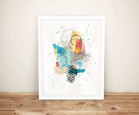 Abstract Skyline II by Courtney Prahl framed print with turquoise, yellow and coral collage shapes leaning on timber floor