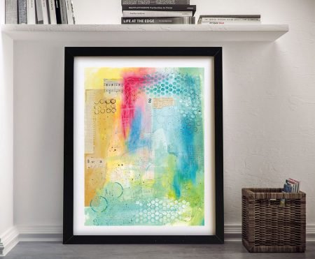 Collage 2 by Courtney Prahl framed art print with turquoise pink and yellow abstract mixed media leaning against white wall