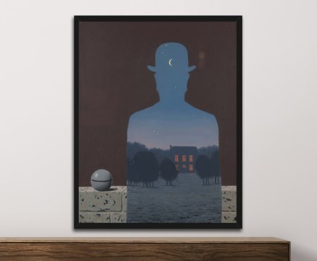 A framed canvas print of René Magritte’s surreal silhouette artwork containing a twilight sky, crescent moon, stars, trees and a warmly lit house.