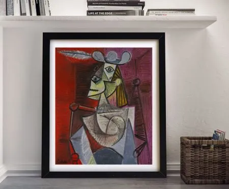 Framed Picasso Woman in an Armchair cubist print with red and purple tones leaning against white wall