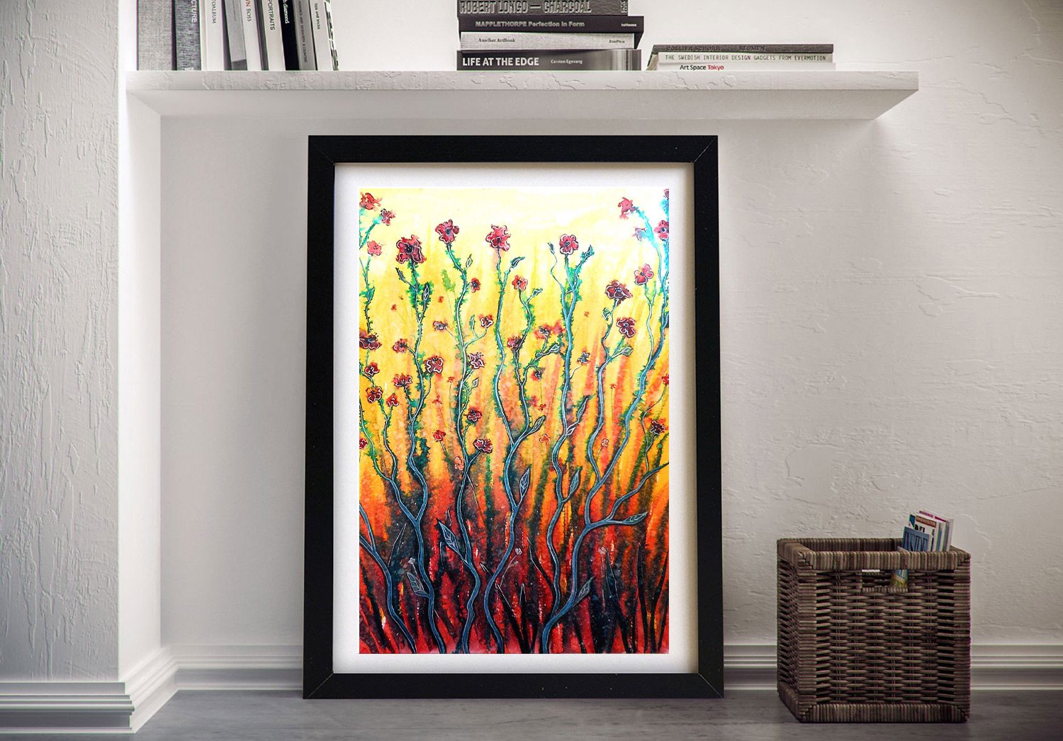 Framed watercolour print of red poppies on fiery yellow and orange background by Linda Callaghan, displayed against white wall