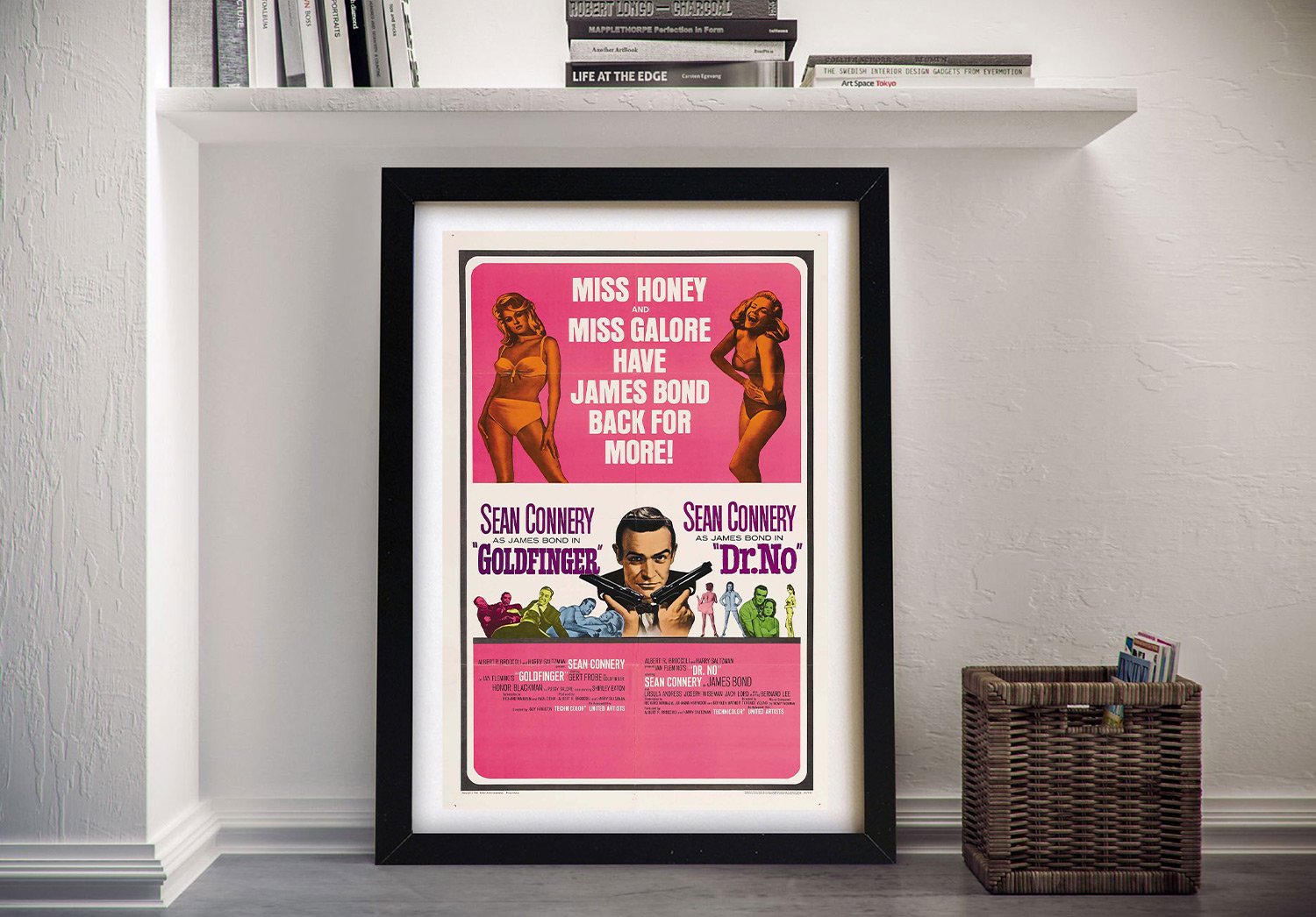 Goldfinger and Dr No vintage cinema print framed in black, leaning beneath a white floating shelf