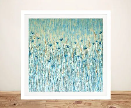 Coastal Wild Flowers framed print featuring blue and gold wildflower meadow artwork in white frame on timber floor