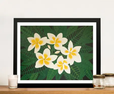 Frangipani Dreams framed print showing white and yellow plumeria flowers against deep green tropical fern foliage on timber shelf