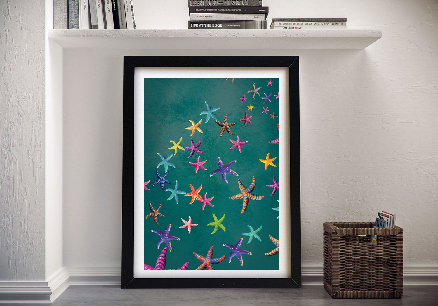 Framed print of colourful patterned starfish on a deep teal background