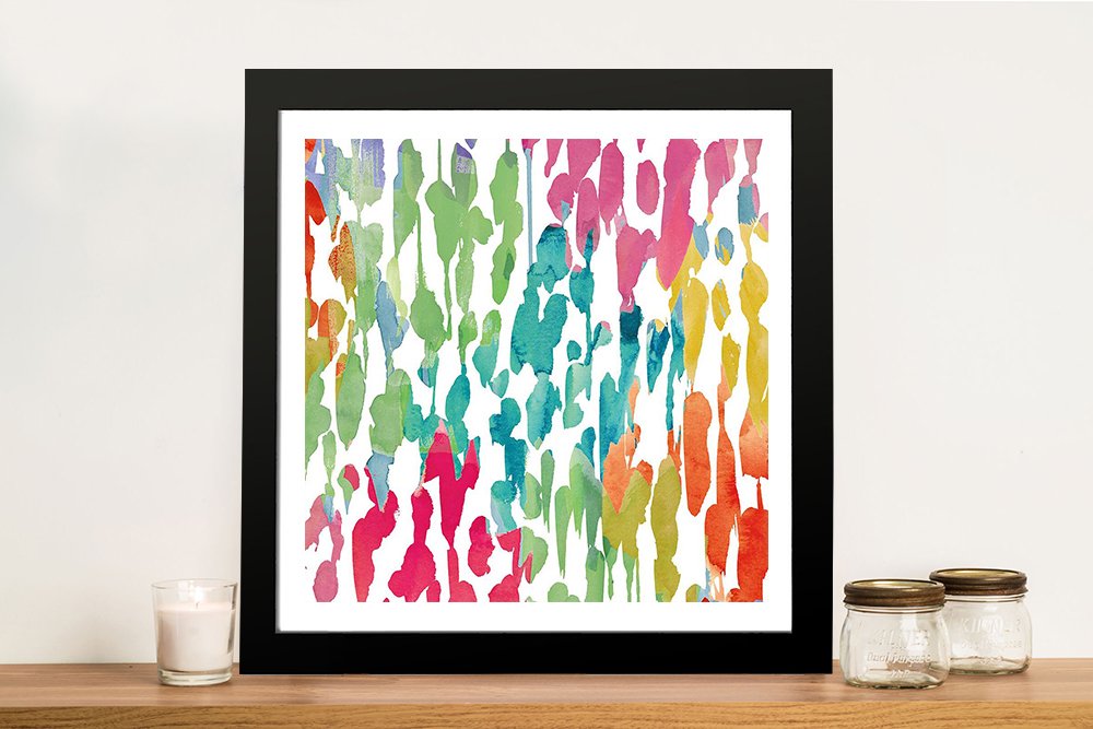 Splashes of Colour abstract watercolour print in black square frame on timber shelf with candle and glass jars