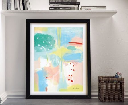 Fresh Face Abstract I framed print with pastel pink, blue, green and yellow brushstrokes leaning against hallway wall