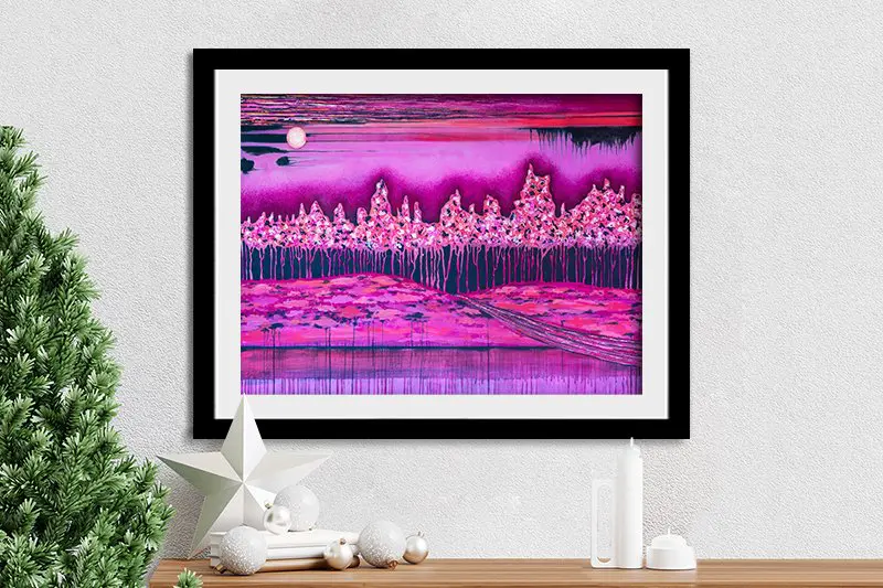 Vibrant pink and magenta abstract landscape print by Lisa Frances Judd in black frame above Christmas styled console
