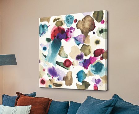 Colourful watercolour abstract canvas print by Shirley Novak with teal, magenta and olive blooms above a blue sofa