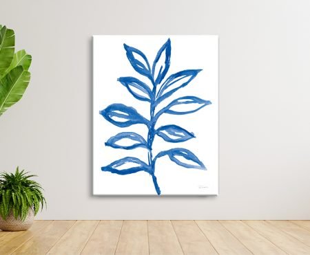 Blue watercolour leaf canvas print by Sue Schlabach hung on white wall beside indoor plants and timber floor