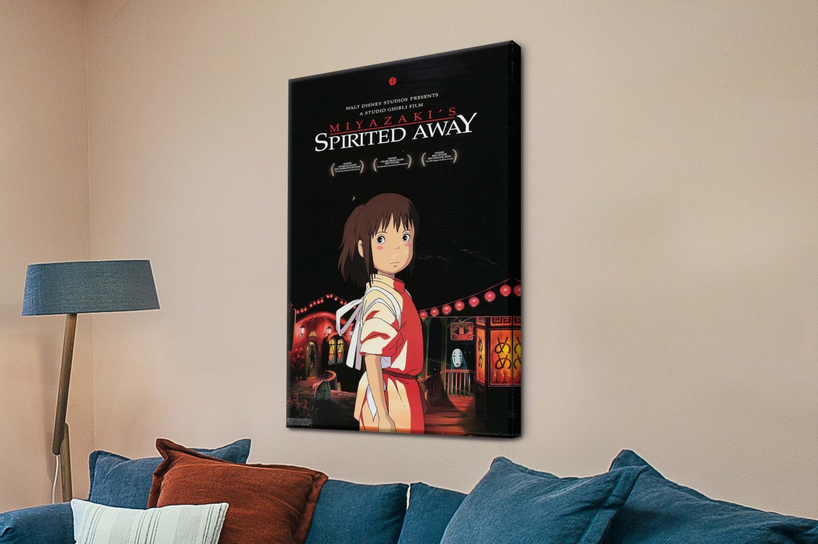 Spirited Away canvas print featuring Chihiro and No-Face displayed above a blue sofa in a warm beige living room