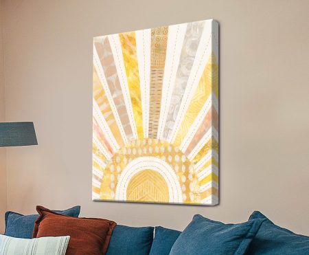 Boho Sunshine I by Courtney Prahl canvas print with golden yellow sunburst design displayed above blue sofa in beige living room