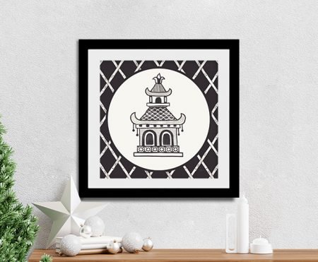 Black and white chinoiserie pagoda framed print by Mary Urban styled on console with Christmas tree and decorations