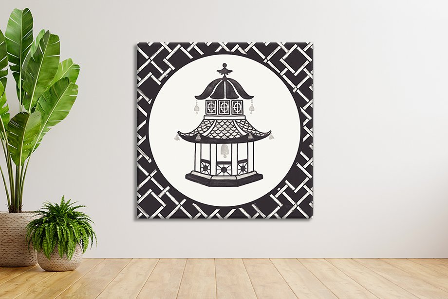 Black and white chinoiserie pagoda canvas print by Mary Urban with bamboo lattice border displayed on white wall above timber floor