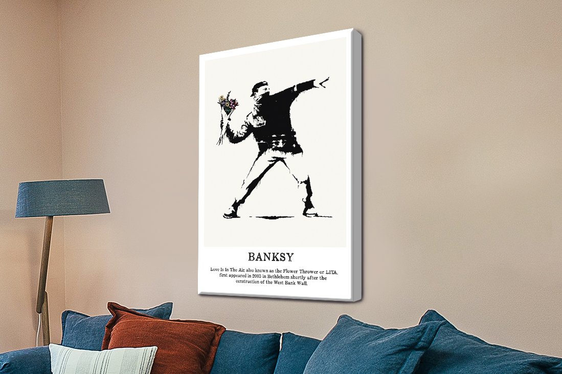 Banksy Flower Thrower canvas print showing a masked figure throwing a colourful bouquet in black and white stencil style