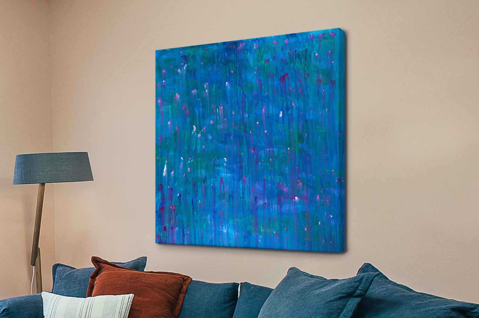 Crying Wind by Helen Joynson abstract square canvas print in blue teal and pink above a navy sofa