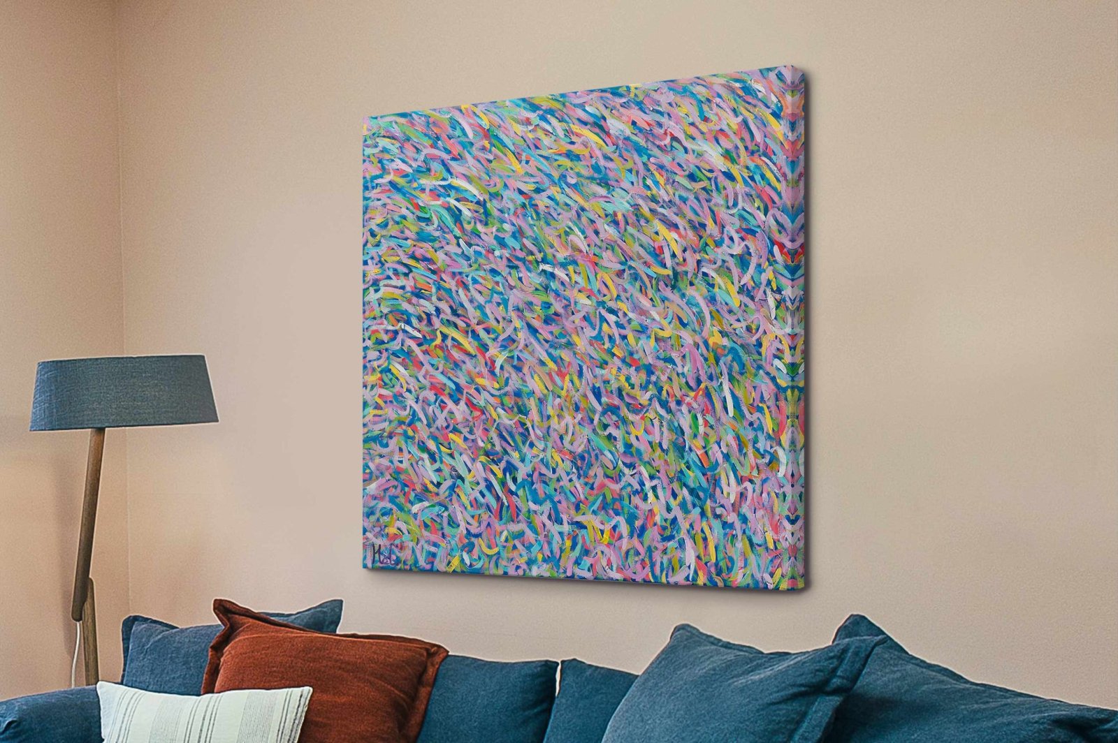 Deep Moving Colours square canvas print with pastel pink, blue and yellow abstract brushstrokes above a blue sofa