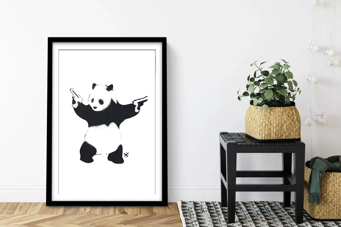 framed Banksy Panda with Guns print, black-and-white stencil panda holding two pistols