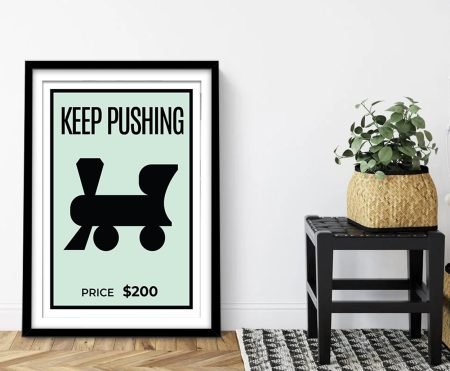 Framed Monopoly-style card reading Keep Cash Flowing in bold lettering
