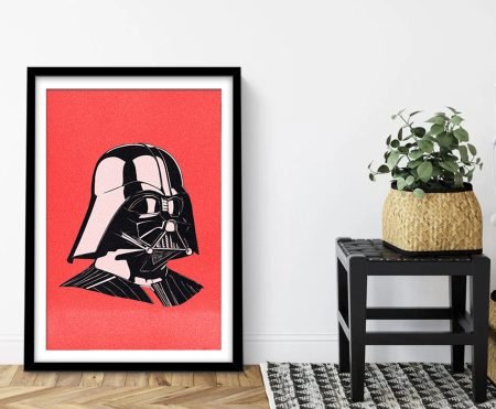 Framed pop-art head-and-shoulders portrait of Darth Vader's helmet on coral