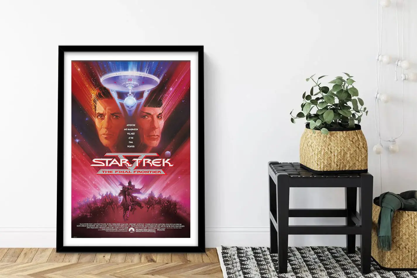 Star Trek V sci-fi movie poster framed and propped beside a black stool with a planter