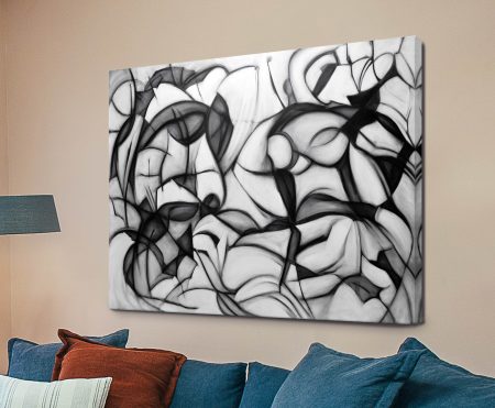 Midnight Frolic black and white abstract canvas print above blue sofa with red cushions in warm beige living room