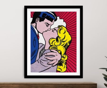 Lichtenstein Kiss III contemporary art print framed in black with white mat on a sideboard