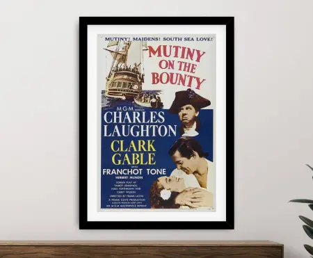 Mutiny on the Bounty old hollywood poster framed in black above a timber sideboard
