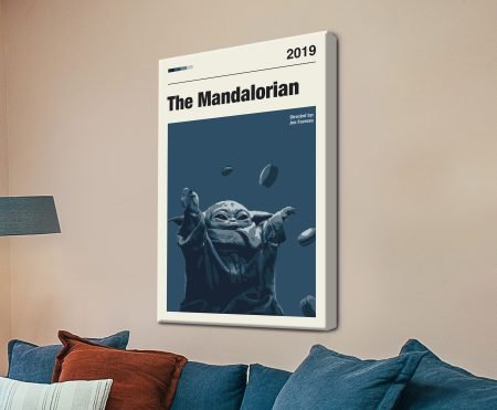 The Mandalorian minimalist star wars wall art canvas above a navy sofa, Grogu lifting macarons in deep blue tones